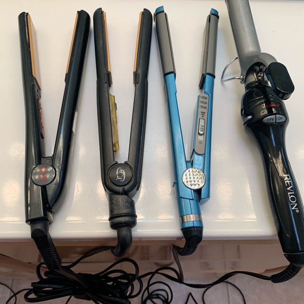 3 flat irons and 1 curling iron